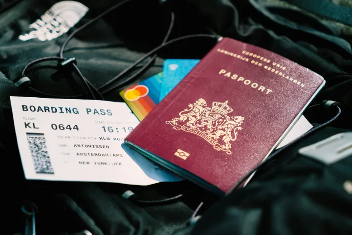Dutch passport and boarding pass on travel luggage